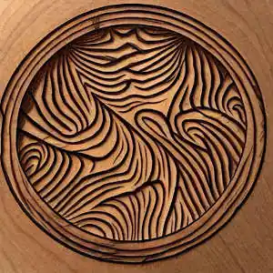 A circular piece of wood with Fractal-style burns